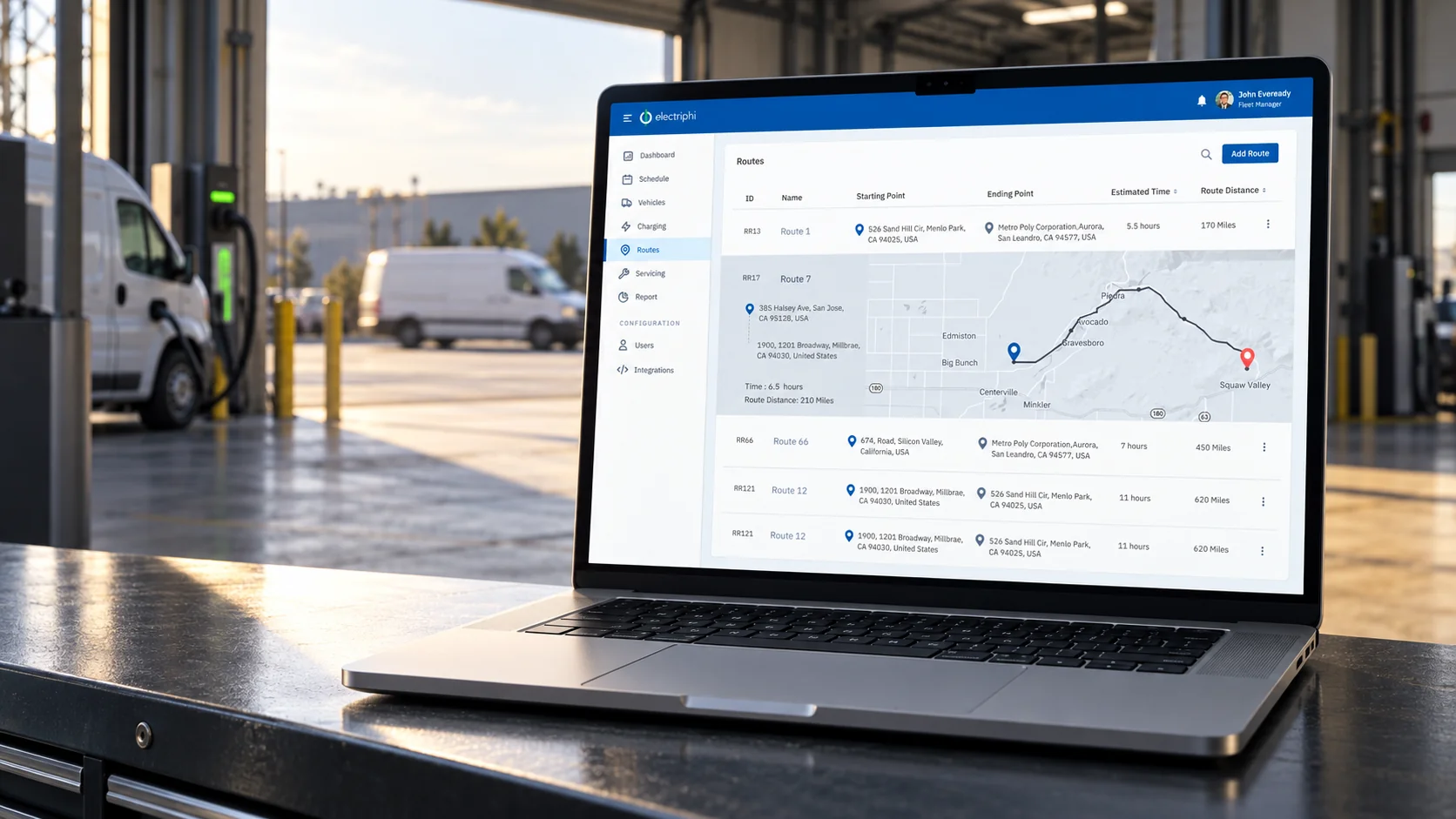 Electriphi route planning presented on a MacBook in a fleet dispatch bay.