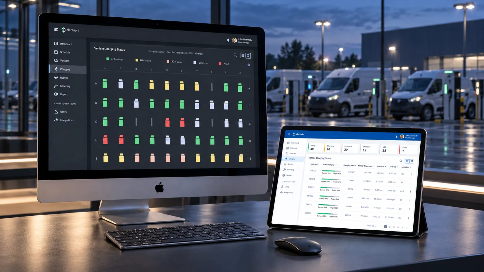 Electriphi vehicle grid and charging list on an iMac and iPad overlooking parked electric vans.